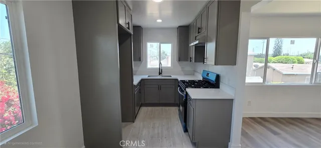 a kitchen with stainless steel appliances granite countertop a stove a sink and a refrigerator