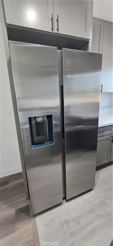 a kitchen with a refrigerator and a sink