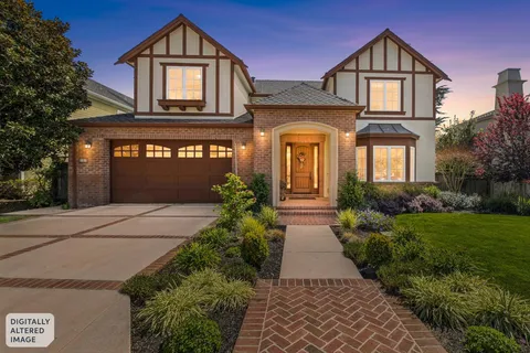 a front view of a house with garden