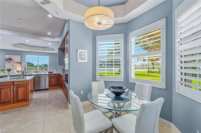 a view of a dining room and livingroom with furniture wooden floor and a chandelier