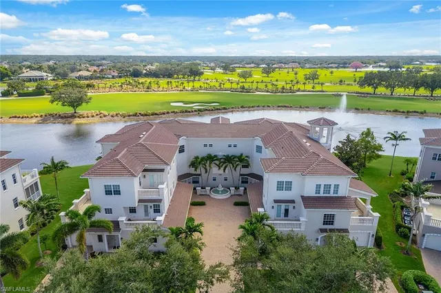 an aerial view of a house with a garden and lake view