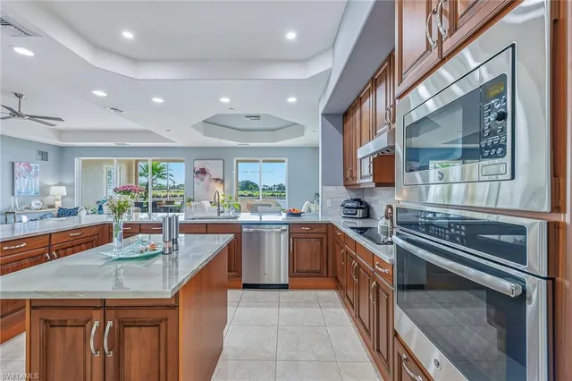 a kitchen with stainless steel appliances granite countertop lots of counter top space and wooden floor