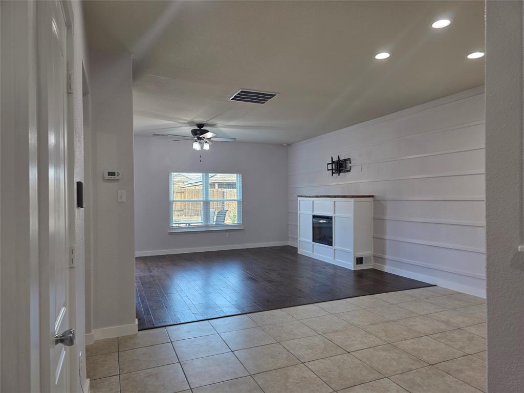 149 Ryan Street Anna, TX 75409 - Photo 4 of 38 wooden floor in an empty room with a window