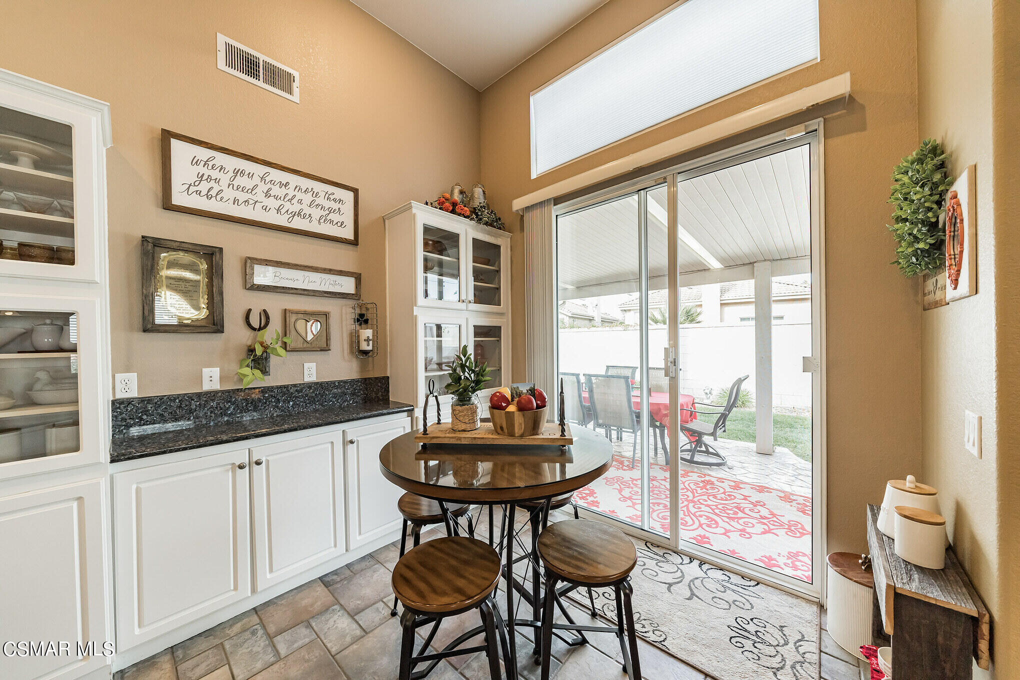 1990 Winterdew Avenue Simi Valley, CA 93065 - Photo 14 of 38 a dining room with granite countertop furniture and a floor to ceiling window