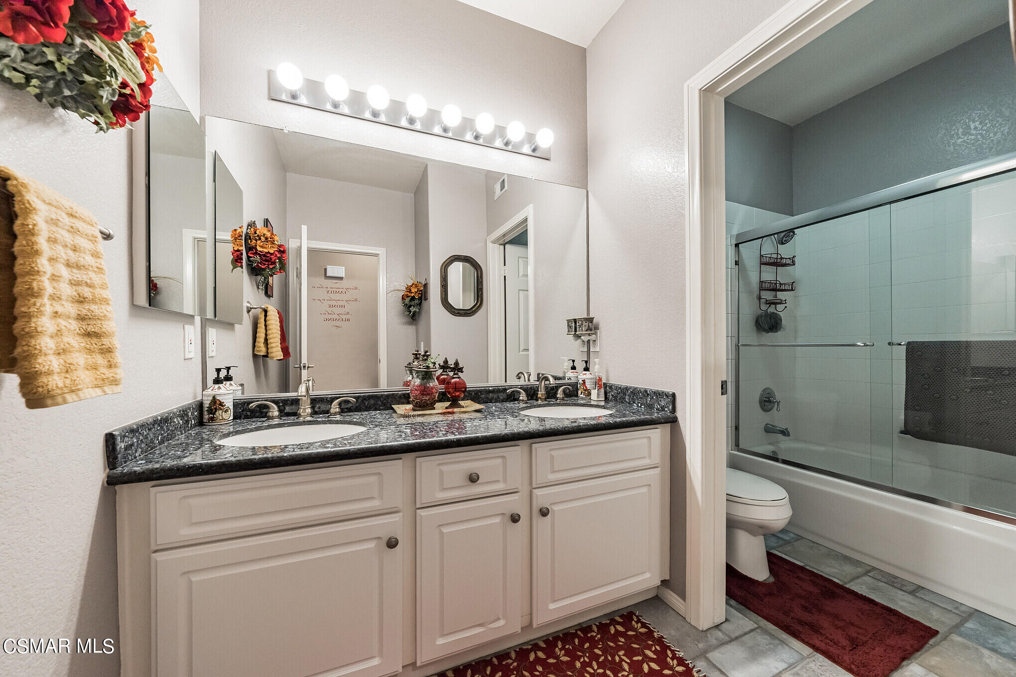 1990 Winterdew Avenue Simi Valley, CA 93065 - Photo 28 of 38 a spacious bathroom with a double vanity sink mirror and toilet