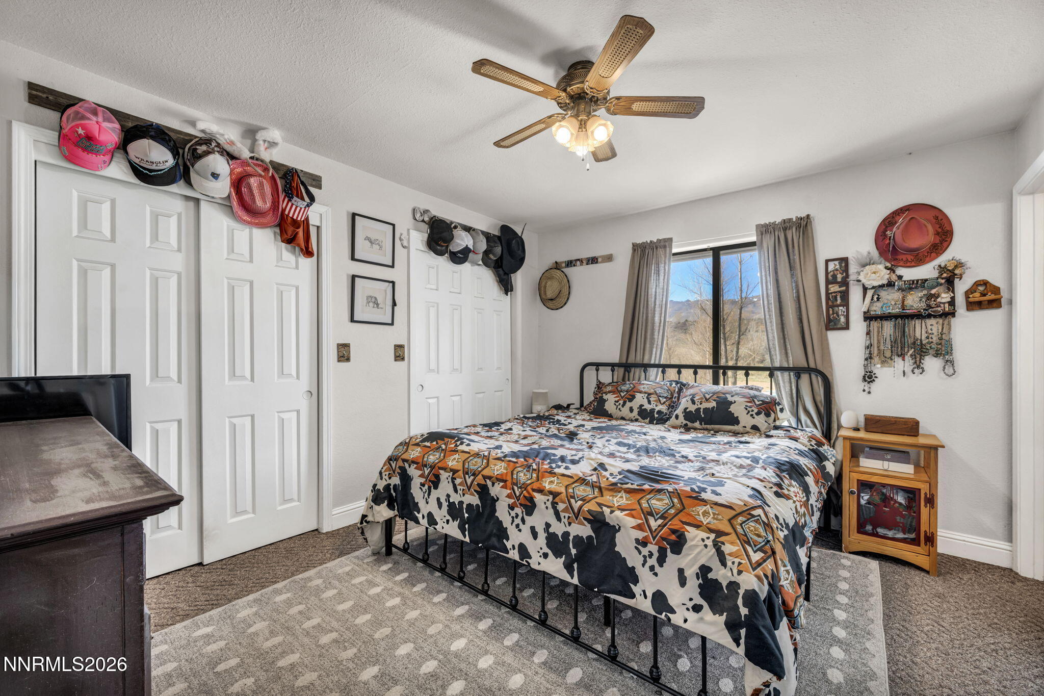 55 Buckboard Circle Reno, NV 89508 - Photo 14 of 39 a bedroom with a bed a dresser and potted plant