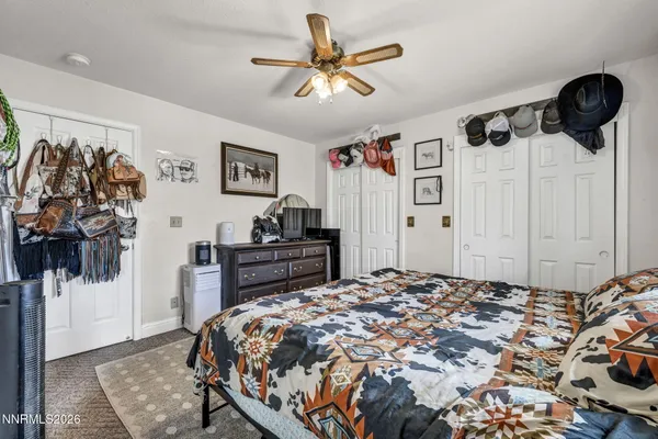 a bedroom with a bed and a wall painting