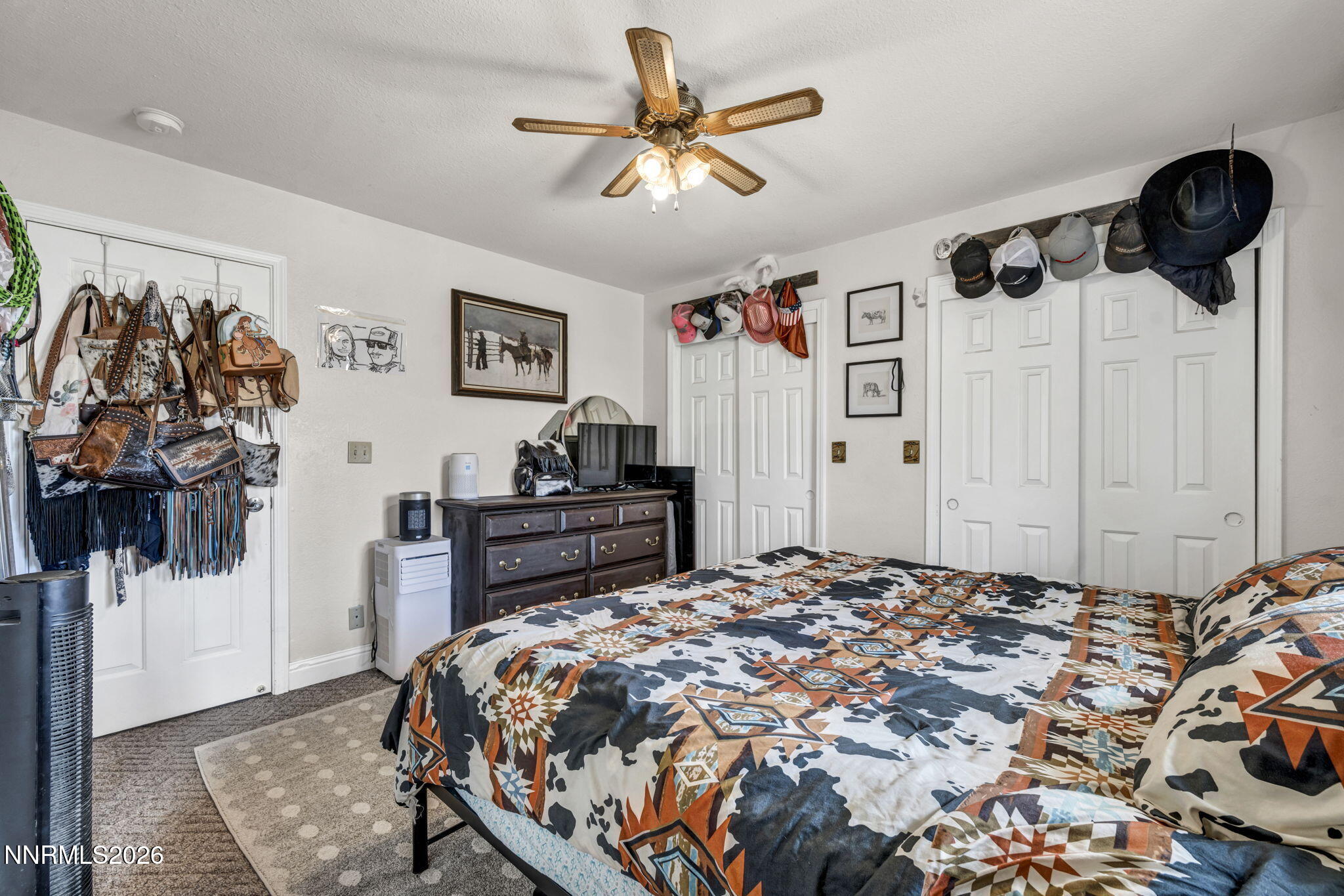 55 Buckboard Circle Reno, NV 89508 - Photo 15 of 39 a bedroom with a bed and a wall painting