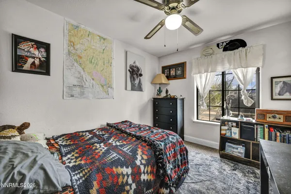 a bedroom with a bed a dresser and book shelf