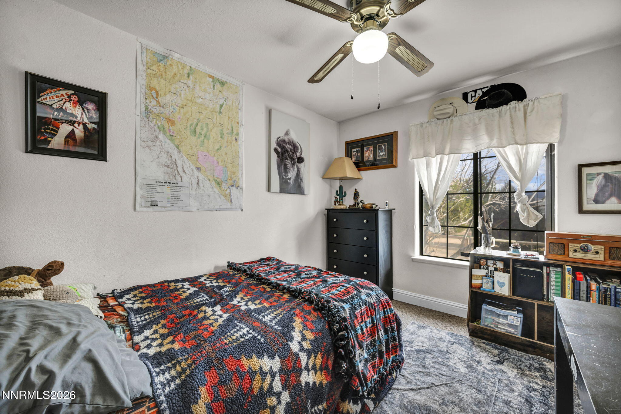 55 Buckboard Circle Reno, NV 89508 - Photo 17 of 39 a bedroom with a bed a dresser and book shelf
