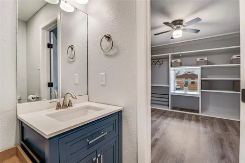 a bathroom with a sink a vanity and a mirror
