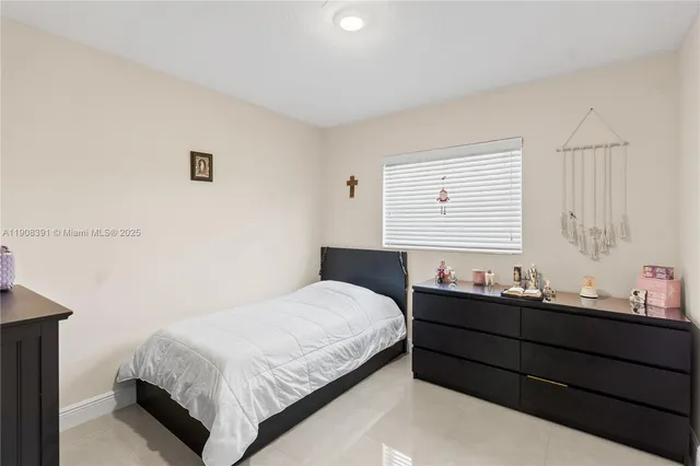 a bedroom with a bed and two windows