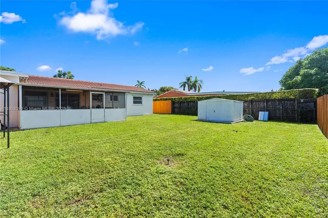 a view of a house with a backyard