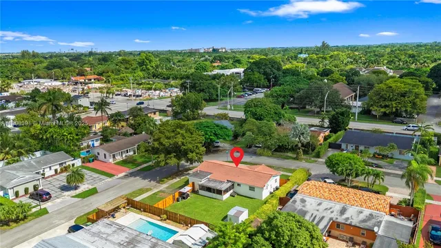 an aerial view of a houses with a yard