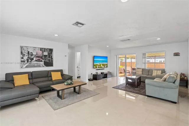 a living room with furniture and a large window