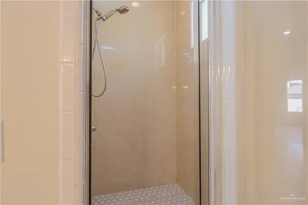 a bathroom with a glass shower door