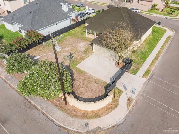 an aerial view of a house with a yard