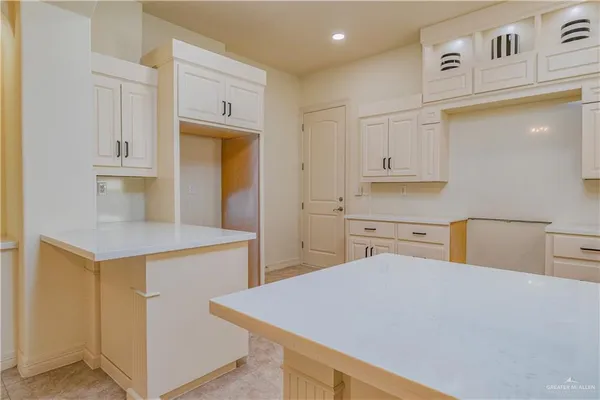 a kitchen with stainless steel appliances cabinets and wooden floor