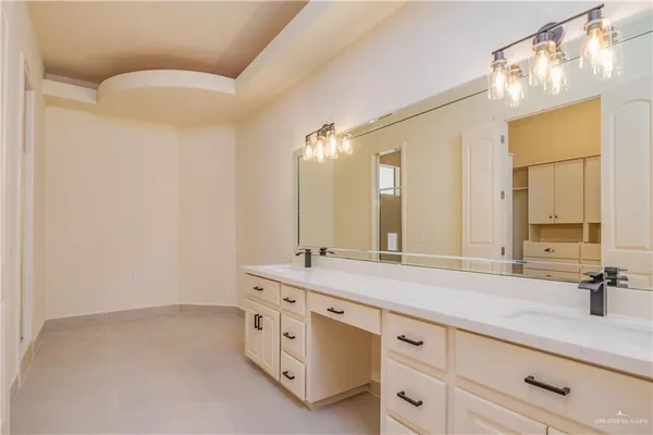 a bathroom with a double vanity sink mirror and