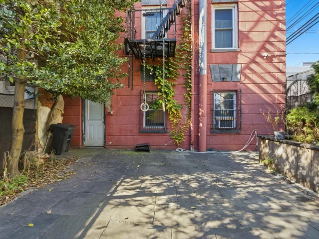 a view of a brick building next to a yard