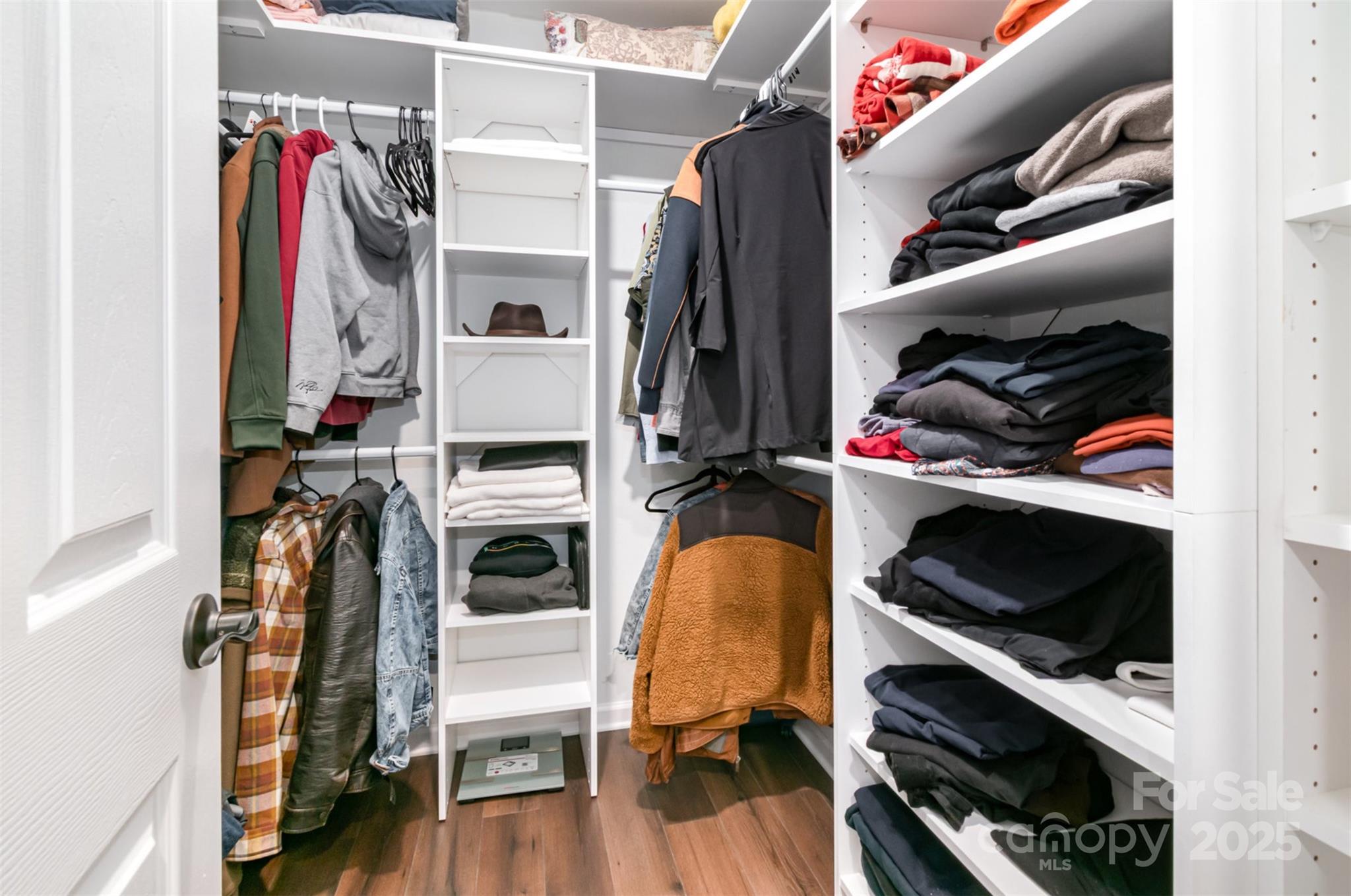 1124 Culver Spring Way Charlotte, NC 28215 - Photo 19 of 32 a view of walk in closet with clothes shoes and a fireplace