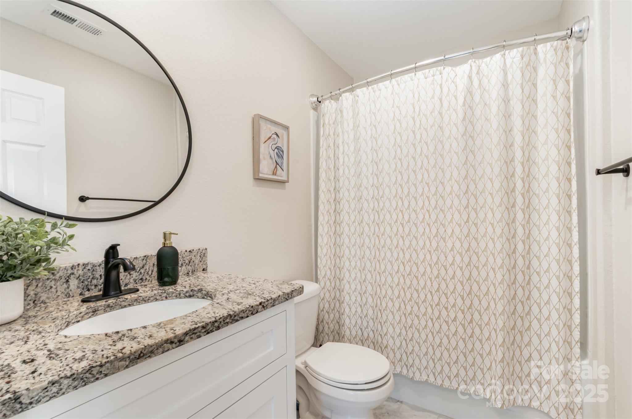 1124 Culver Spring Way Charlotte, NC 28215 - Photo 22 of 32 a bathroom with a granite countertop sink and a mirror