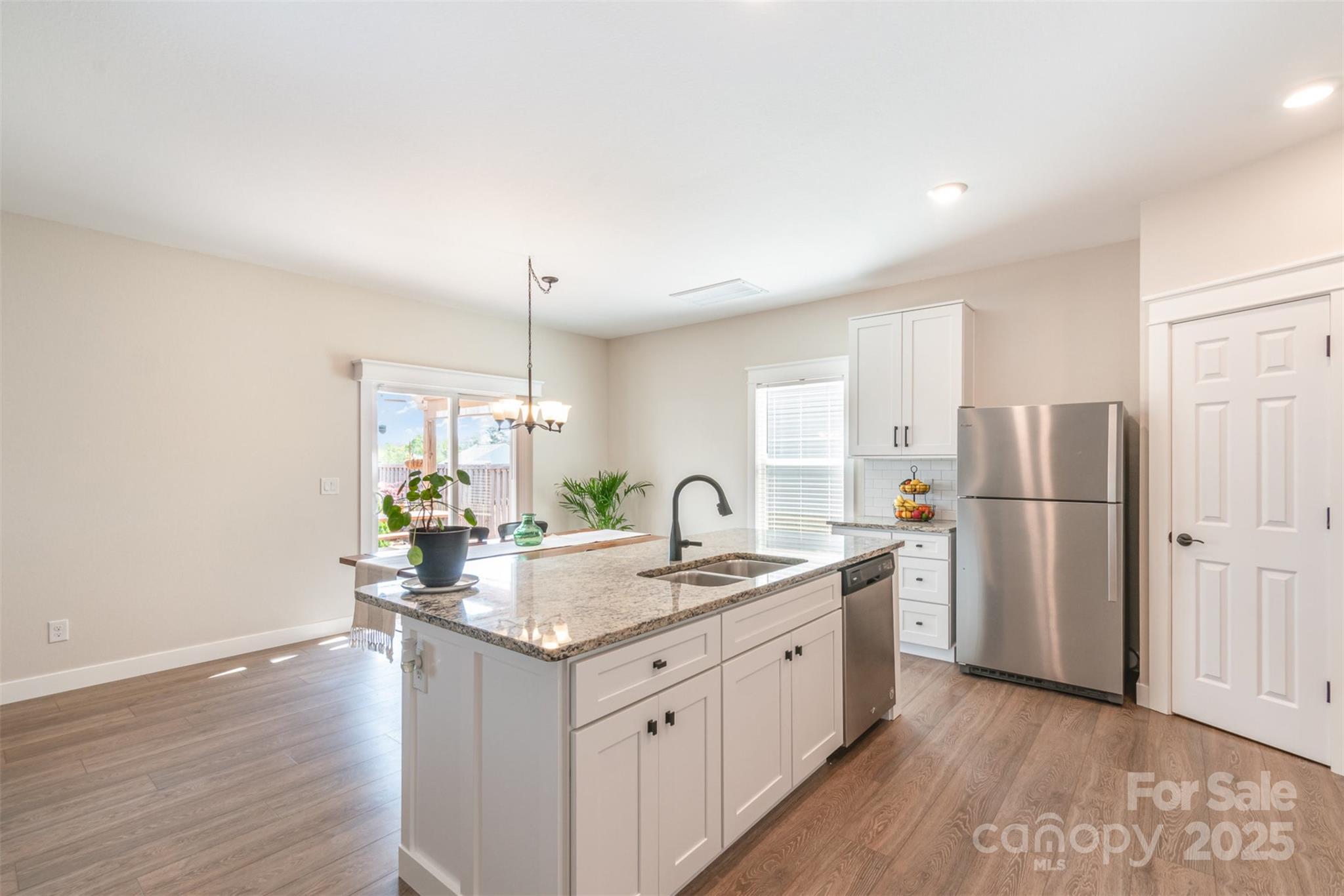 1124 Culver Spring Way Charlotte, NC 28215 - Photo 4 of 32 a kitchen with a sink refrigerator and wooden floor