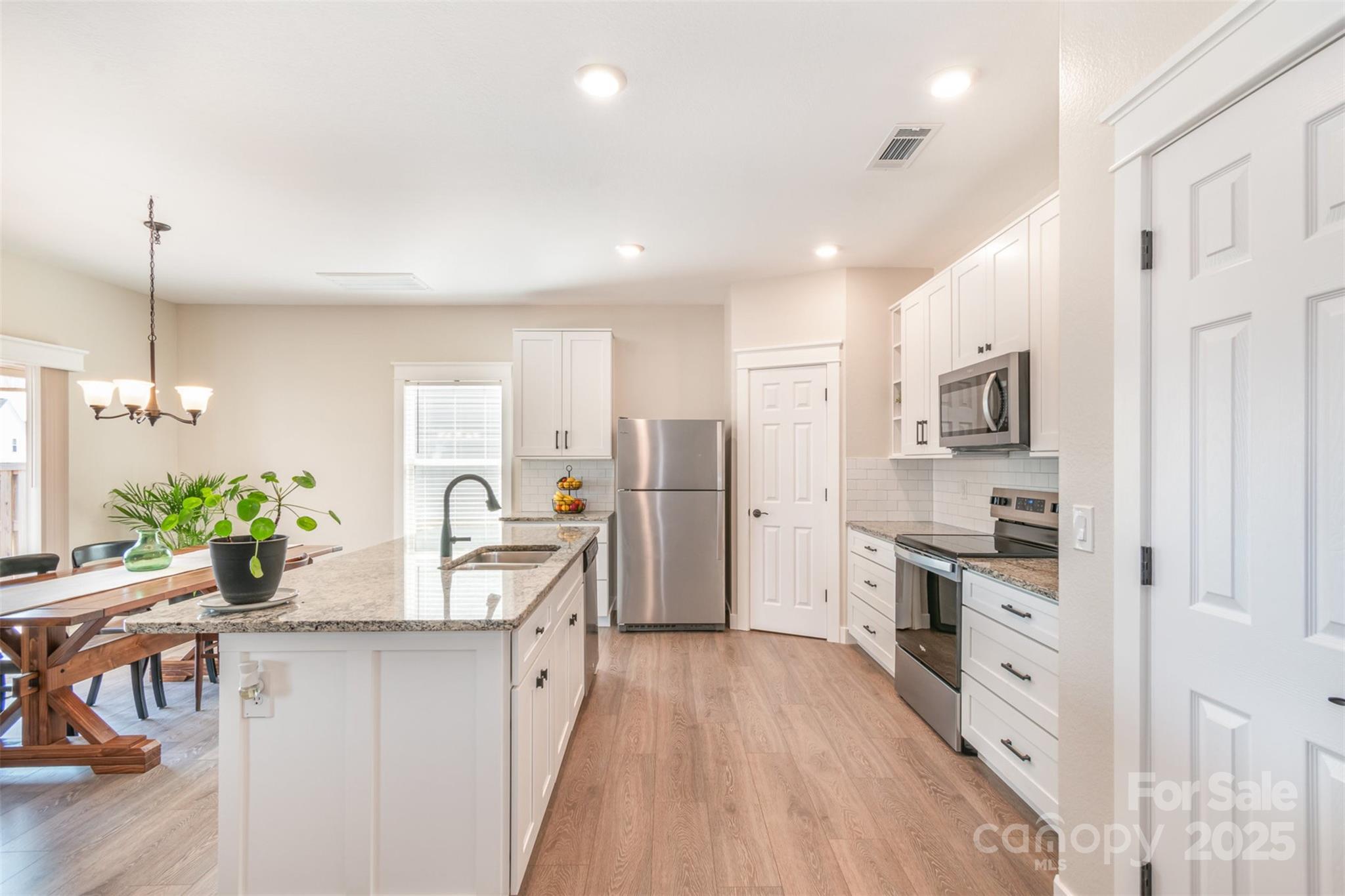 1124 Culver Spring Way Charlotte, NC 28215 - Photo 5 of 32 a kitchen with stainless steel appliances kitchen island granite countertop a refrigerator and a stove top oven