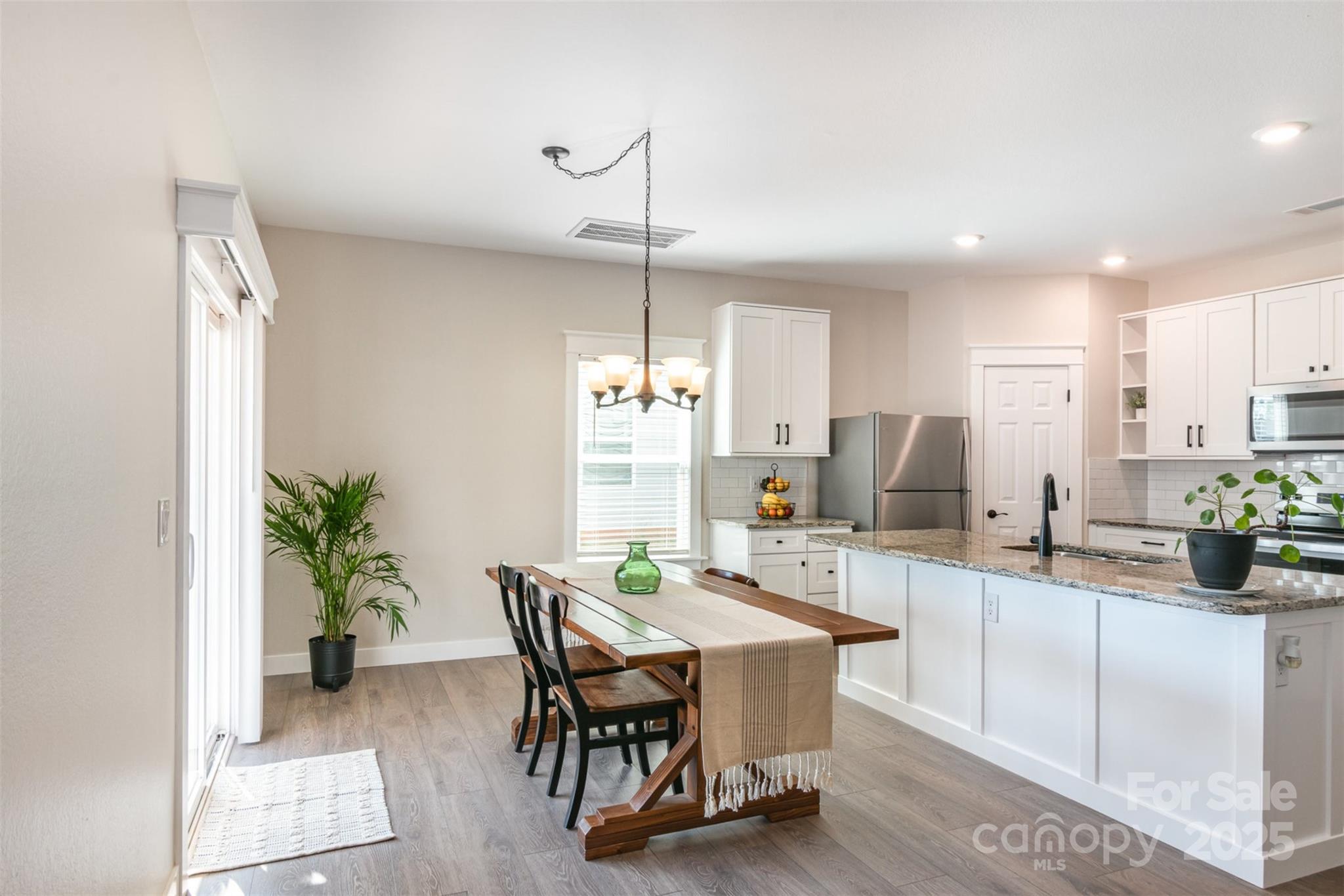 1124 Culver Spring Way Charlotte, NC 28215 - Photo 7 of 32 a kitchen with a table and chairs in it