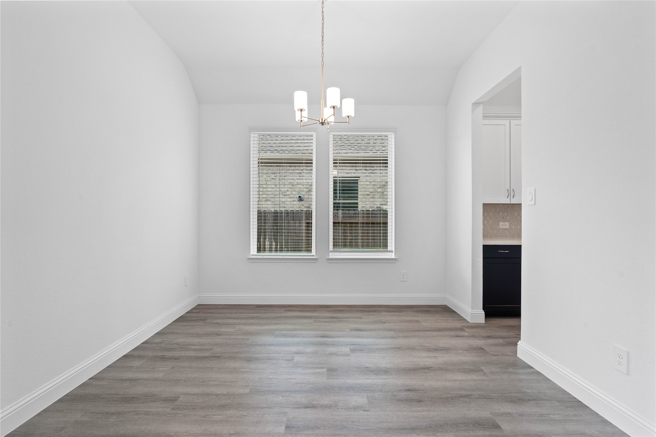 17315 July Moon Lane Conroe, TX 77302 - Photo 11 of 46 a view of an empty room with wooden floor and a window