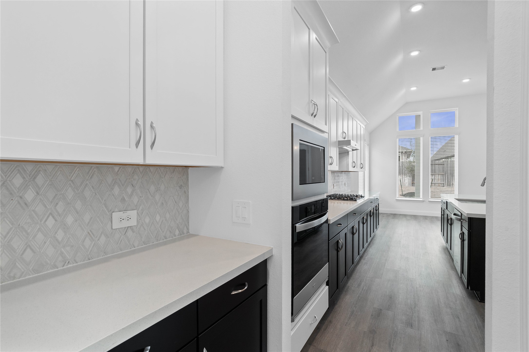 17315 July Moon Lane Conroe, TX 77302 - Photo 12 of 46 a kitchen with stainless steel appliances a sink stove and cabinets