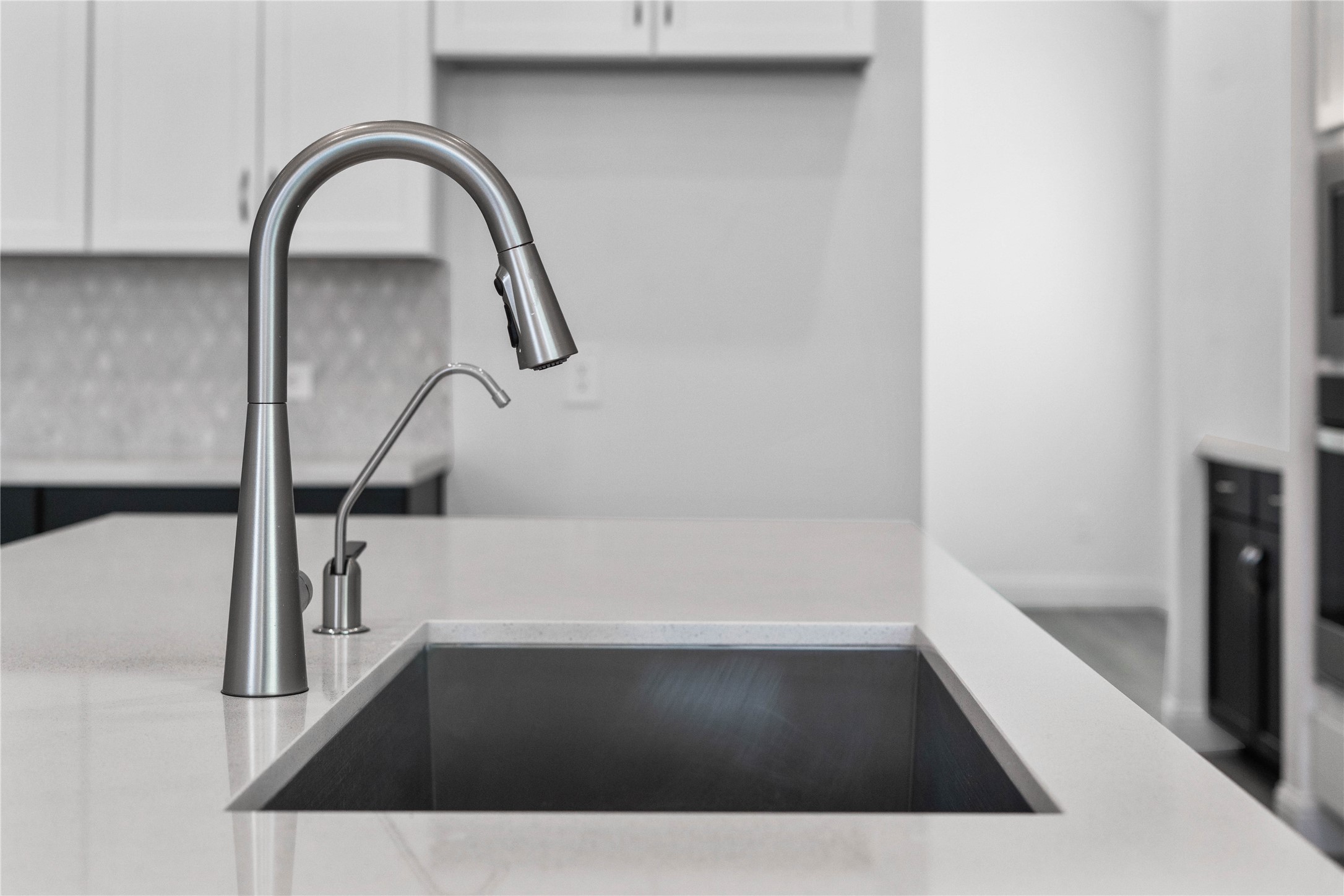 17315 July Moon Lane Conroe, TX 77302 - Photo 16 of 46 Moen Sleek Stainless Steel faucet offers versatility and contemporary design, complemented by a convenient separate filtered water dispenser faucet.