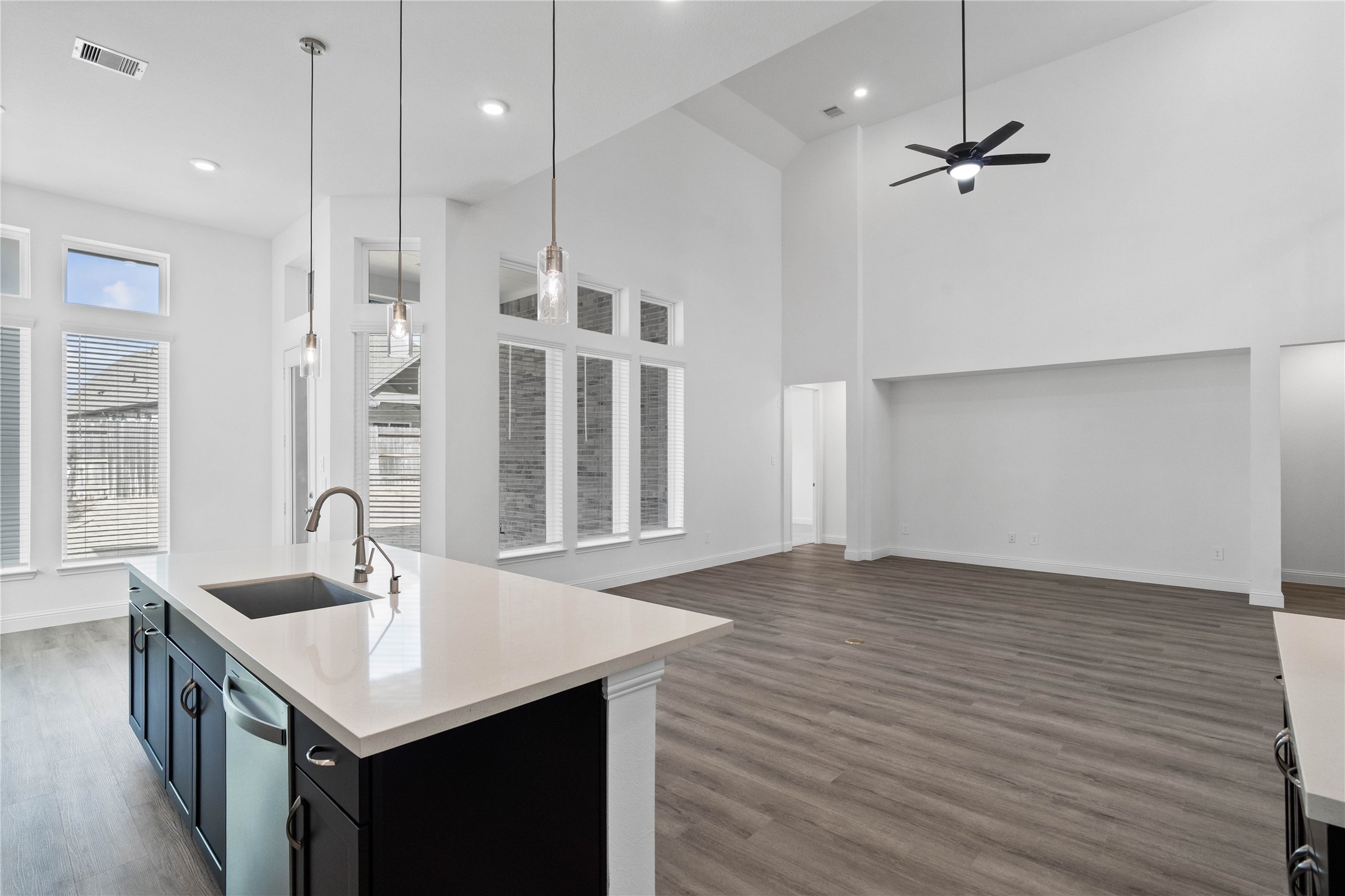 17315 July Moon Lane Conroe, TX 77302 - Photo 19 of 46 a kitchen with a sink chandelier and wooden floor