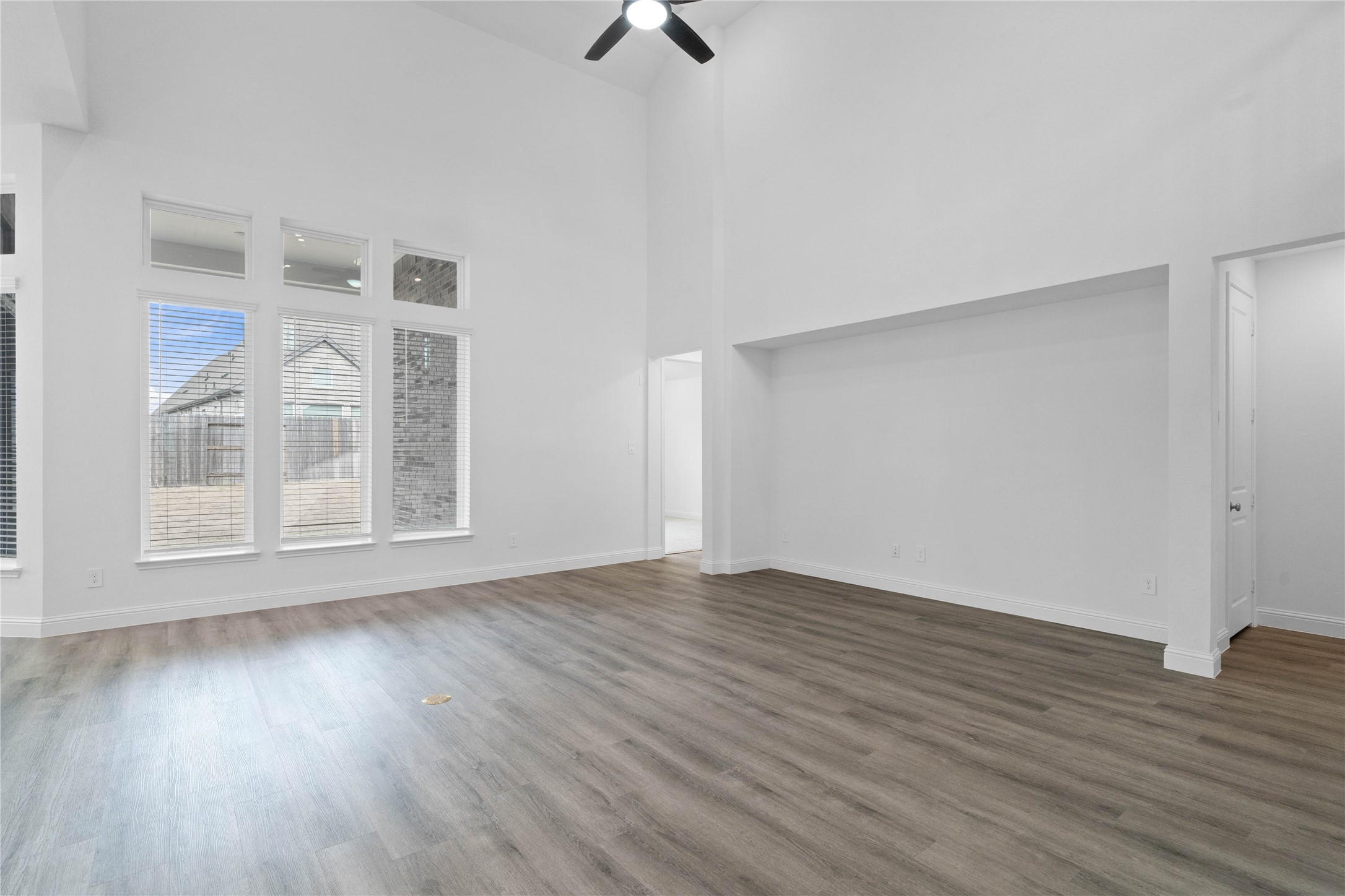 17315 July Moon Lane Conroe, TX 77302 - Photo 21 of 46 a view of an empty room with wooden floor and a window
