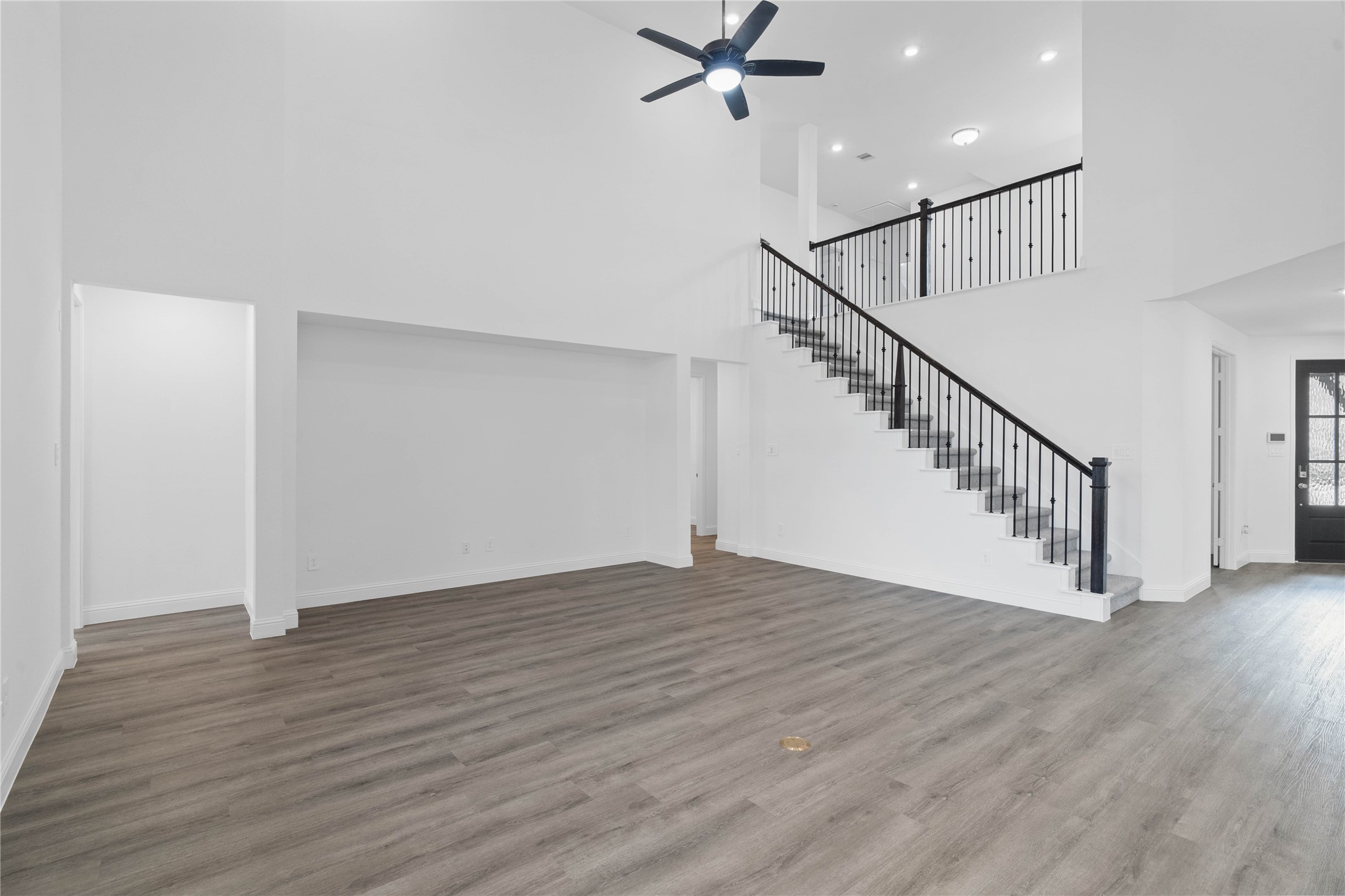 17315 July Moon Lane Conroe, TX 77302 - Photo 22 of 46 a view of an empty room with wooden floor and stairs
