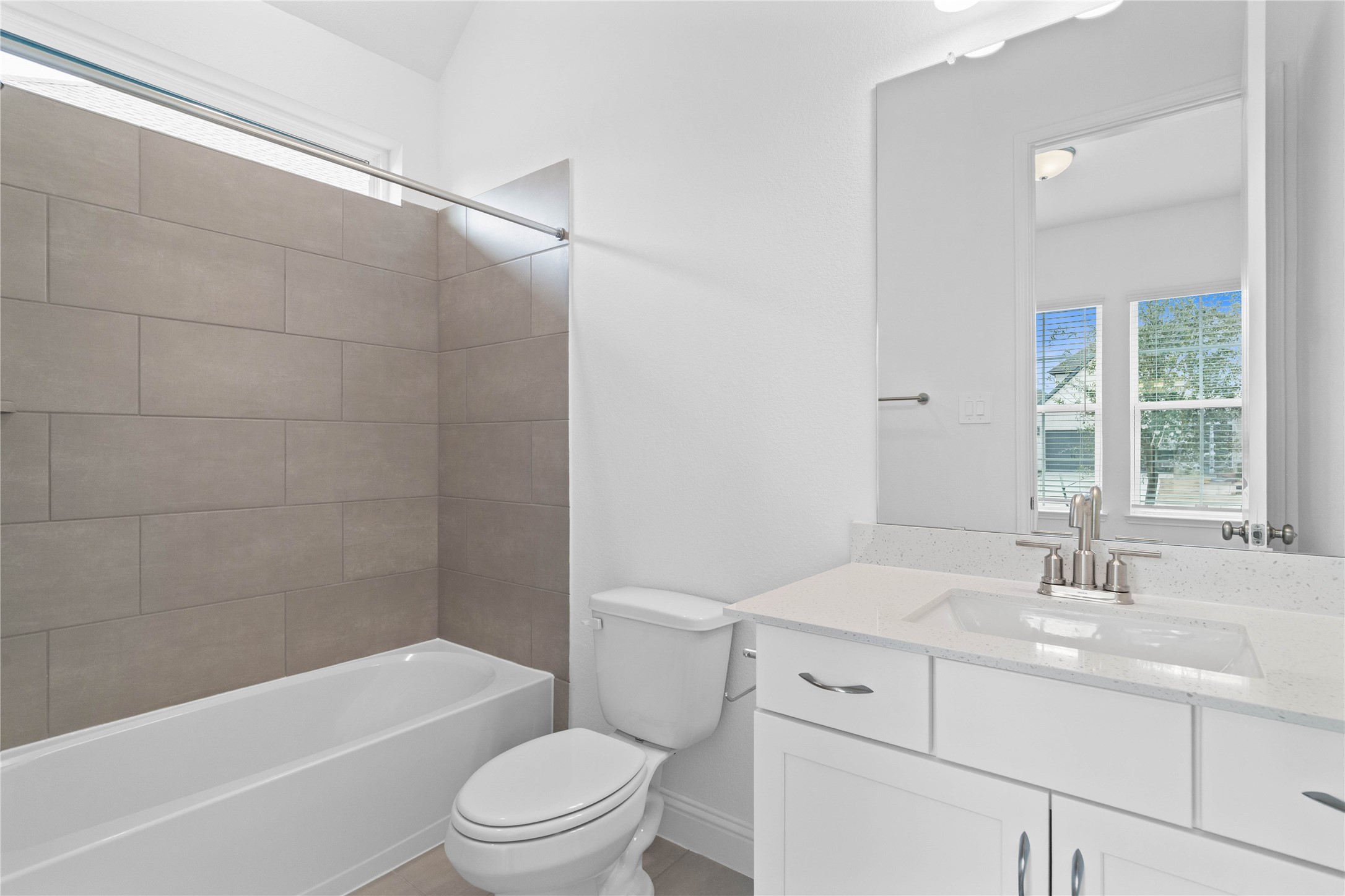 17315 July Moon Lane Conroe, TX 77302 - Photo 10 of 46 This ensuite secondary bathroom features a modern vanity, tub/shower combination with tile surround, and neutral finishes.