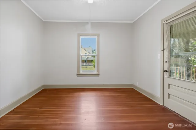 a view of a room with wooden floor and window