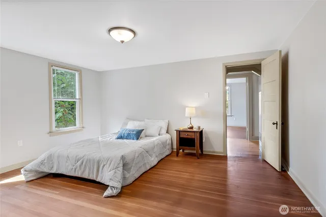 a bedroom with a bed and a lamp