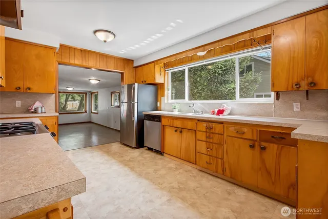 a kitchen with stainless steel appliances kitchen island granite countertop a sink and cabinets