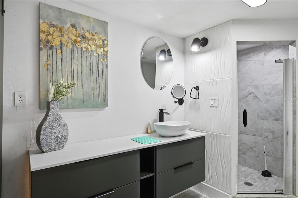 4107 Magnolia Drive Ellenton, FL 34222 - Photo 18 of 41 a bathroom with a sink a mirror and a shower