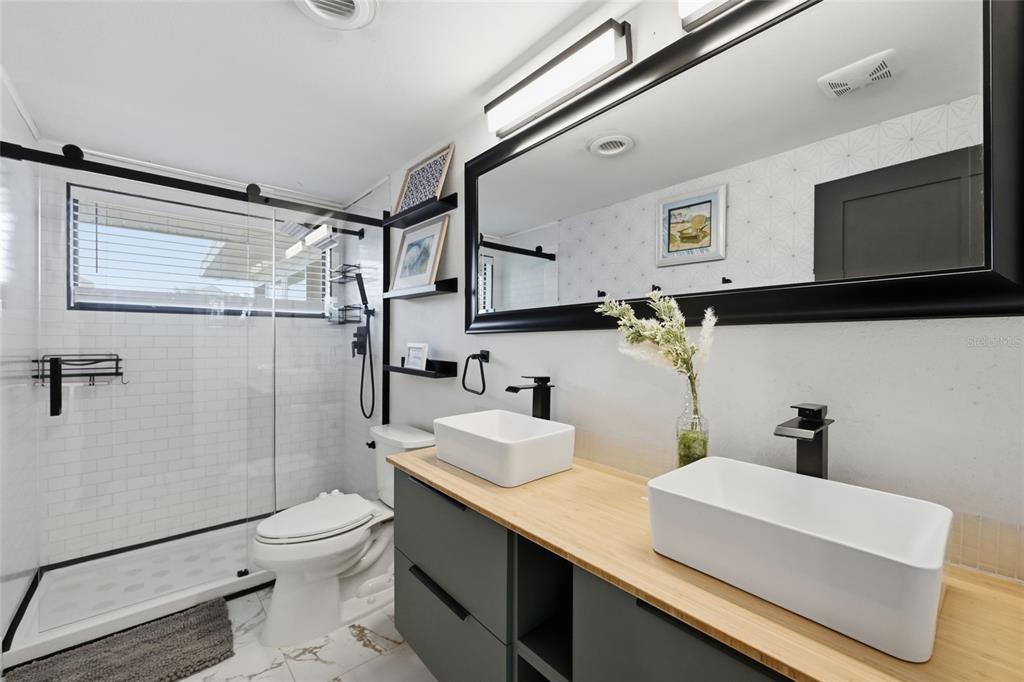 4107 Magnolia Drive Ellenton, FL 34222 - Photo 21 of 41 a bathroom with a sink a toilet and shower