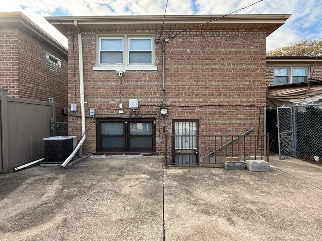 a backyard of a house with barbeque oven