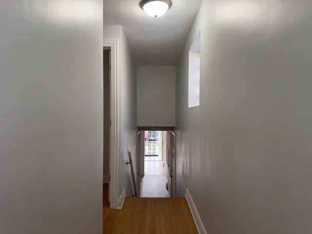 a view of hallway with wooden floor