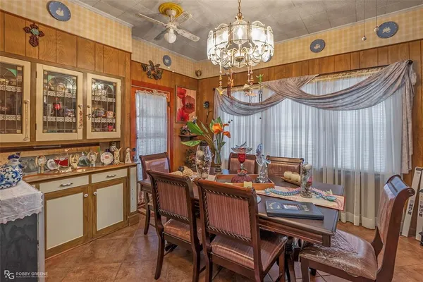 a view of a dining room with furniture a chandelier and wooden floor