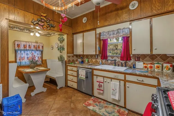a kitchen with stainless steel appliances granite countertop a sink and cabinets