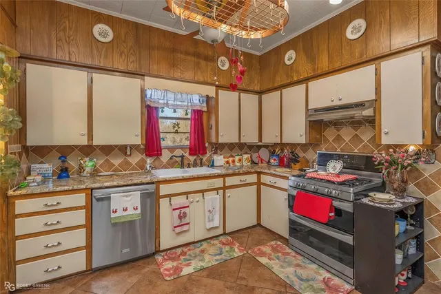 a kitchen with stainless steel appliances granite countertop a sink stove and cabinets