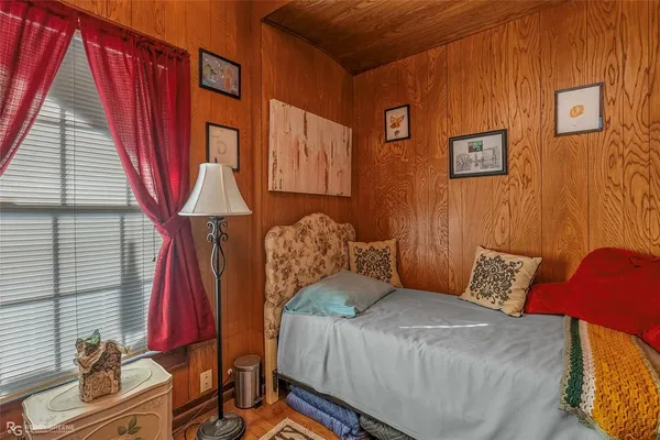 a bedroom with a bed next to a window