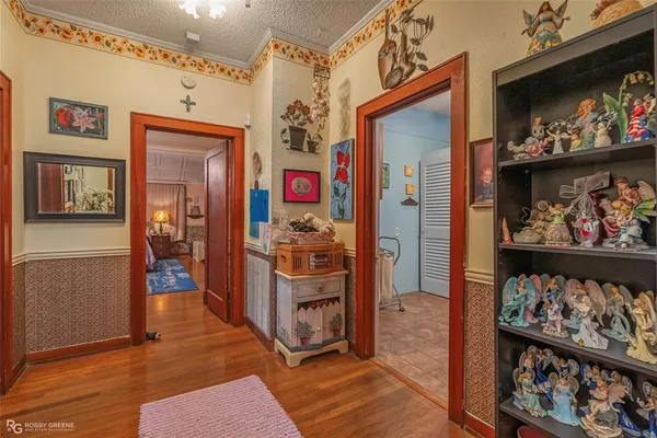 a view of a hallway with wooden floor and furniture