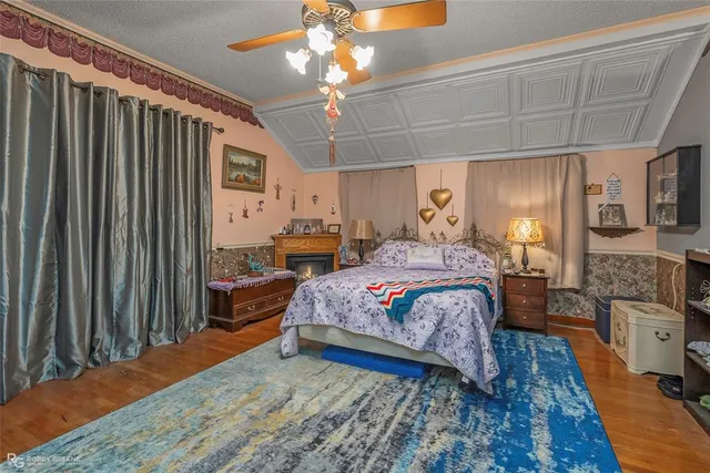 a spacious bedroom with a balcony a bed and a chandelier