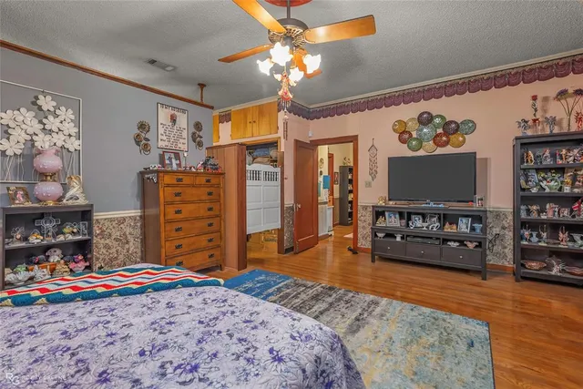 a bedroom with furniture and flat screen tv